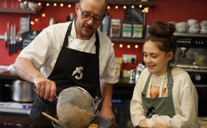 image of chef and child cooking together at Big little cooks at Food Sorcery cookery school Didsbury Manchester