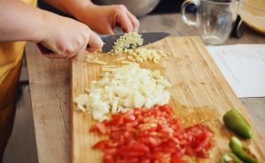 image of Farzana Ullah chopping at Indian cookery classes at the cookery school Manchester near Cheshire