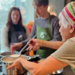 image of Thai cookery class and cooking together at Deansgate Square Manchester