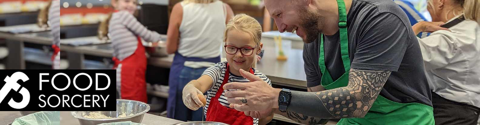 image of parent and child cooking together at food sorcery cookery school