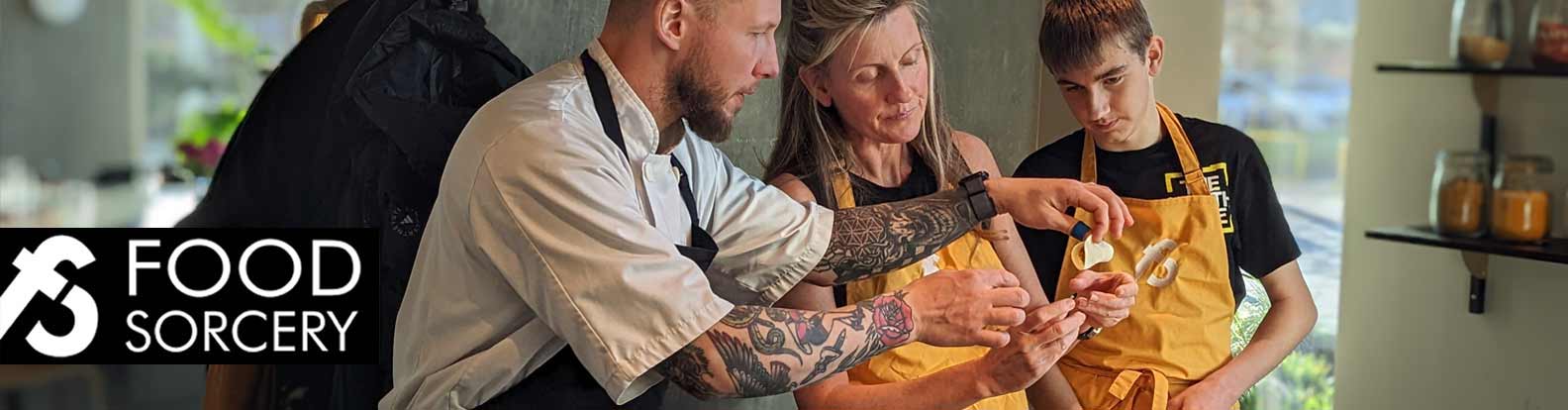 image of parent and child cooking together at food sorcery cookery school